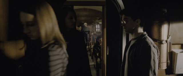 Wide shot frame from Harry Potter and the Half-Blood Prince — standing, room, door