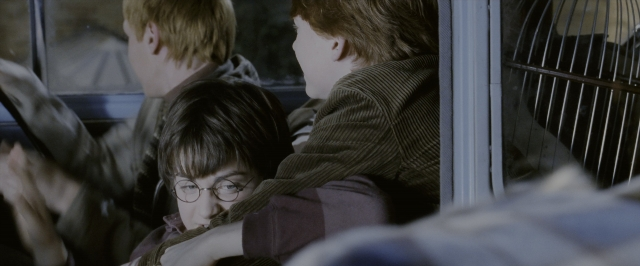 Wide shot frame from Harry Potter and the Chamber of Secrets — people, sitting, action