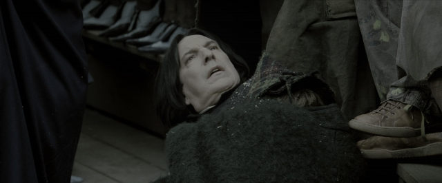 Wide shot frame from Harry Potter and the Goblet of Fire — room, coat, face