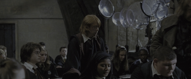 Wide shot frame from Harry Potter and the Goblet of Fire — sitting, standing, room