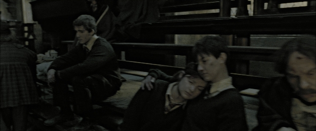 Wide shot frame from Harry Potter and the Deathly Hallows - Part 2 — sitting, room, suit
