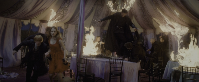 Wide shot frame from Harry Potter and the Deathly Hallows - Part 1 — table, fire, suit