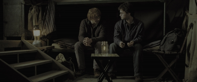 Wide shot frame from Harry Potter and the Deathly Hallows - Part 1 — sitting, room, table