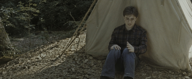 Wide shot frame from Harry Potter and the Deathly Hallows - Part 1 — sitting, tent, shirt