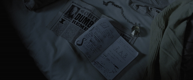 Wide shot frame from Harry Potter and the Deathly Hallows - Part 1 — book, bed, newspaper