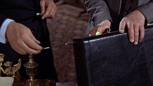 Wide shot frame from From Russia with Love — sitting, standing, room