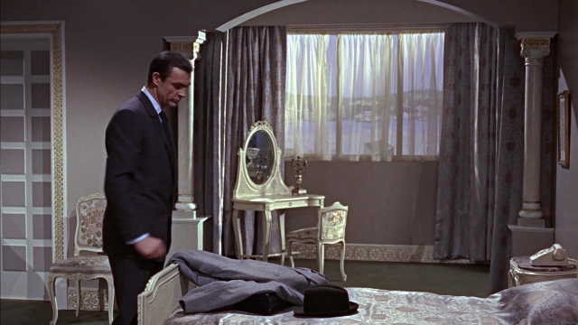 Wide shot frame from From Russia with Love — standing, room, table