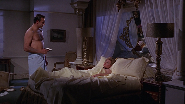 Frame from From Russia with Love — standing, room, table