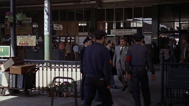 Wide shot frame from From Russia with Love — walking, street, suit