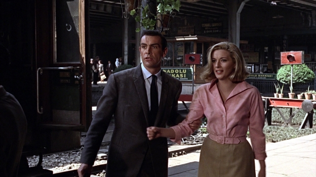 Wide shot frame from From Russia with Love — walking, dialogue, coat
