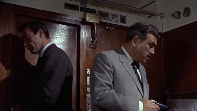 Frame from From Russia with Love — room, bed, door
