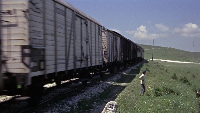 Wide shot frame from From Russia with Love — standing, car, train