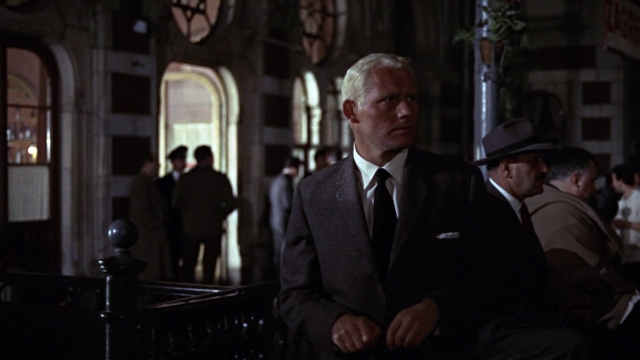 Wide shot frame from From Russia with Love — sitting, standing, room