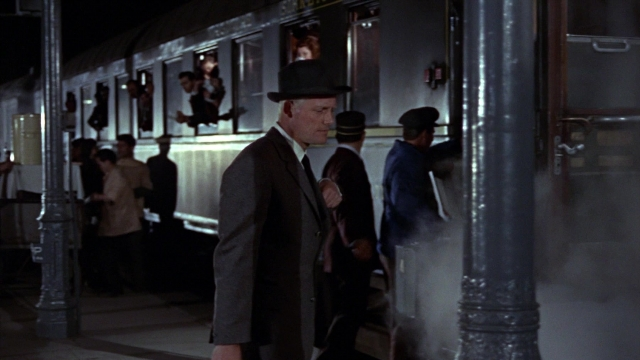 Wide shot frame from From Russia with Love — standing, hat, hand