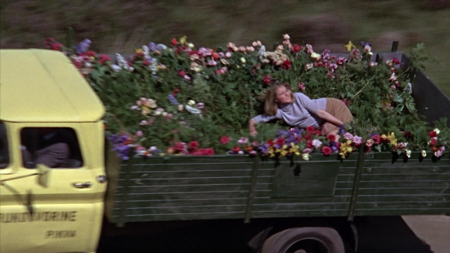 Wide shot frame from From Russia with Love — bed, street, shirt