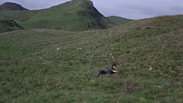 Wide shot frame from From Russia with Love — sitting, hat, dog