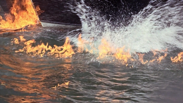 Wide shot frame from From Russia with Love — fire, water, smoke