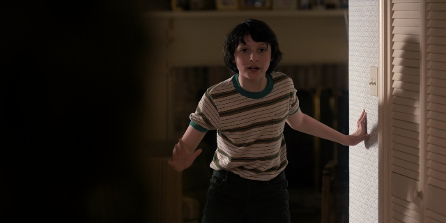 Wide shot frame from Stranger Things — people, action, standing