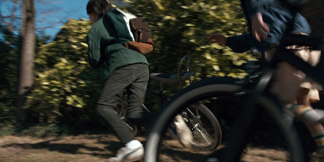 Wide shot frame from Stranger Things — bicycle, person, footwear