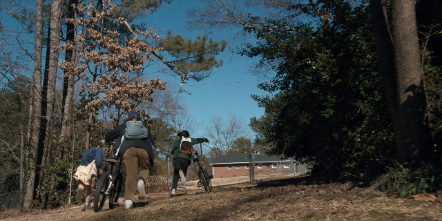 Wide shot frame from Stranger Things — people, group, walking