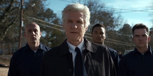 Wide shot frame from Stranger Things — standing, street, coat