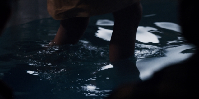 Wide shot frame from Stranger Things — standing, water, person