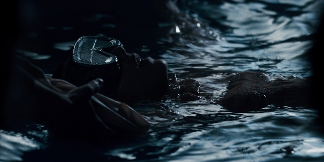 Wide shot frame from Stranger Things — hat, water, person