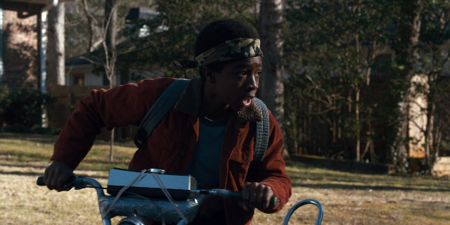 Wide shot frame from Stranger Things — dialogue, bicycle, person
