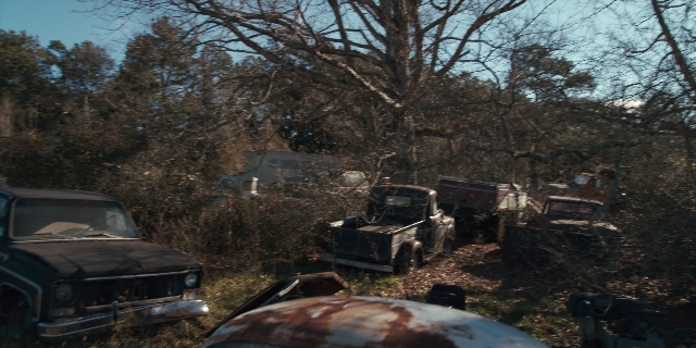 Wide shot frame from Stranger Things — car, wheel, land vehicle
