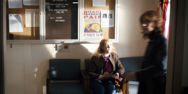 Wide shot frame from Stranger Things — sitting, standing, room