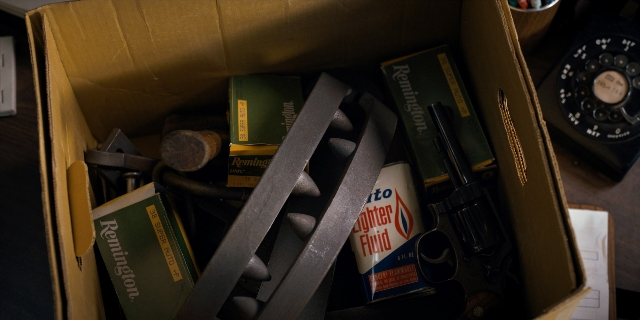 Wide shot frame from Stranger Things — sitting, table, phone