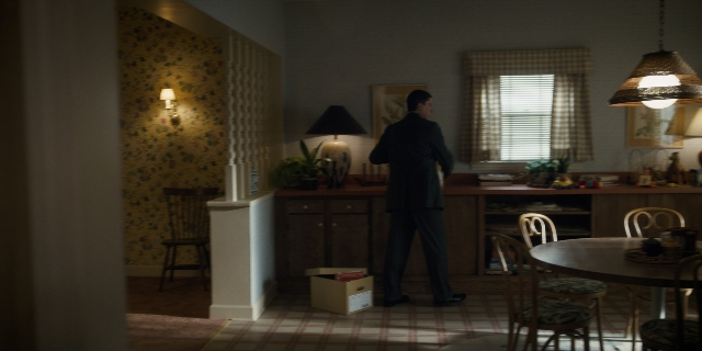 Wide shot frame from Stranger Things — standing, table, dialogue