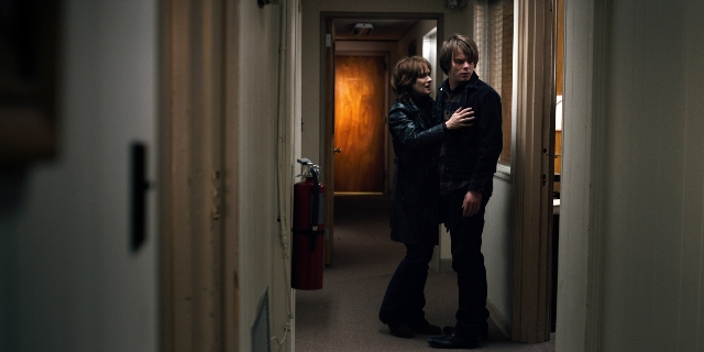 Wide shot frame from Stranger Things — standing, door, fire