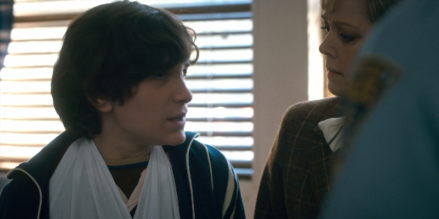 Wide shot frame from Stranger Things — room, dialogue, face