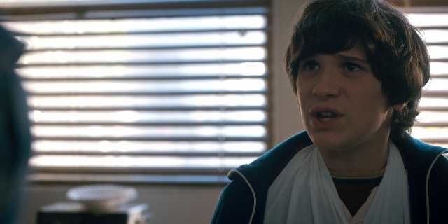 Medium shot frame from Stranger Things — standing, room, face