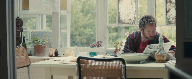Wide shot frame from About Time — sitting, table, house