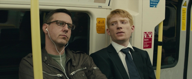 Medium shot frame from About Time — sitting, suit, tie
