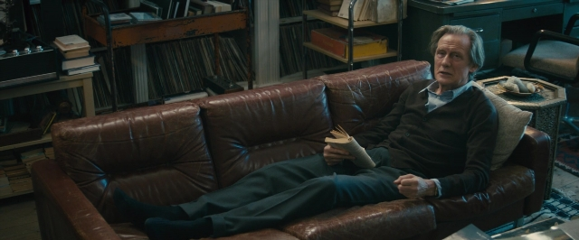 Wide shot frame from About Time — sitting, book, room