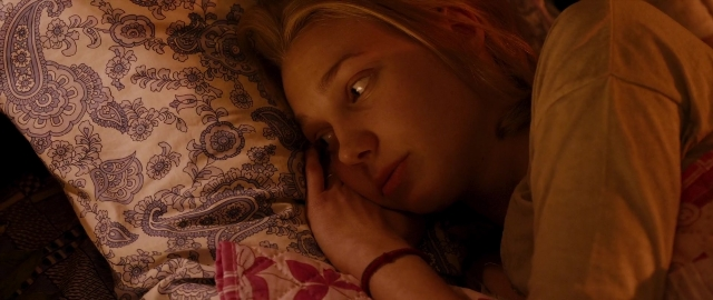 Wide shot frame from Kak menya zovut — bed, hand, dress