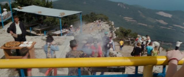 Wide shot frame from Kak menya zovut — standing, plate, table