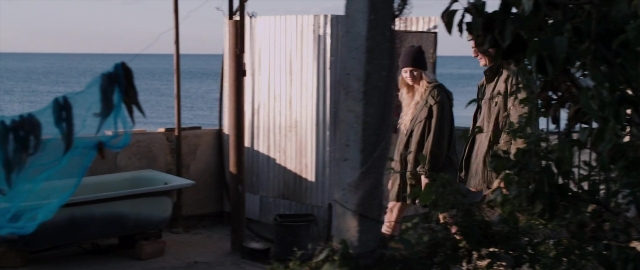 Frame from Kak menya zovut — standing, hat, coat