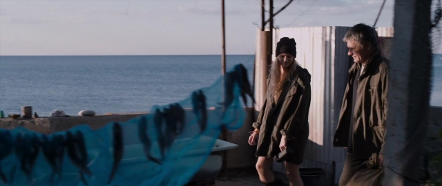 Wide shot frame from Kak menya zovut — standing, dialogue, hat