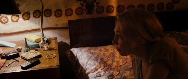 Wide shot frame from Kak menya zovut — sitting, book, room