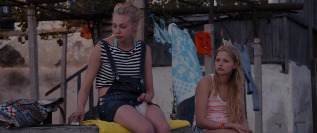 Wide shot frame from Kak menya zovut — sitting, phone, bag