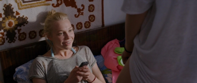 Wide shot frame from Kak menya zovut — sitting, standing, room