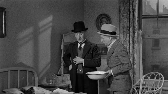 Frame from Limelight — standing, room, bed