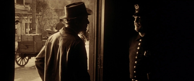 Wide shot frame from Butch Cassidy and the Sundance Kid — standing, hat, uniform