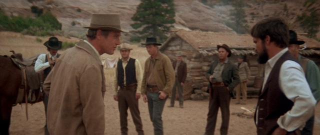 Wide shot frame from Butch Cassidy and the Sundance Kid — standing, dialogue, hat