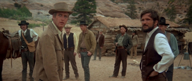 Medium shot frame from Butch Cassidy and the Sundance Kid — standing, dialogue, hat