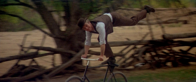 Wide shot frame from Butch Cassidy and the Sundance Kid — street, bicycle, shirt